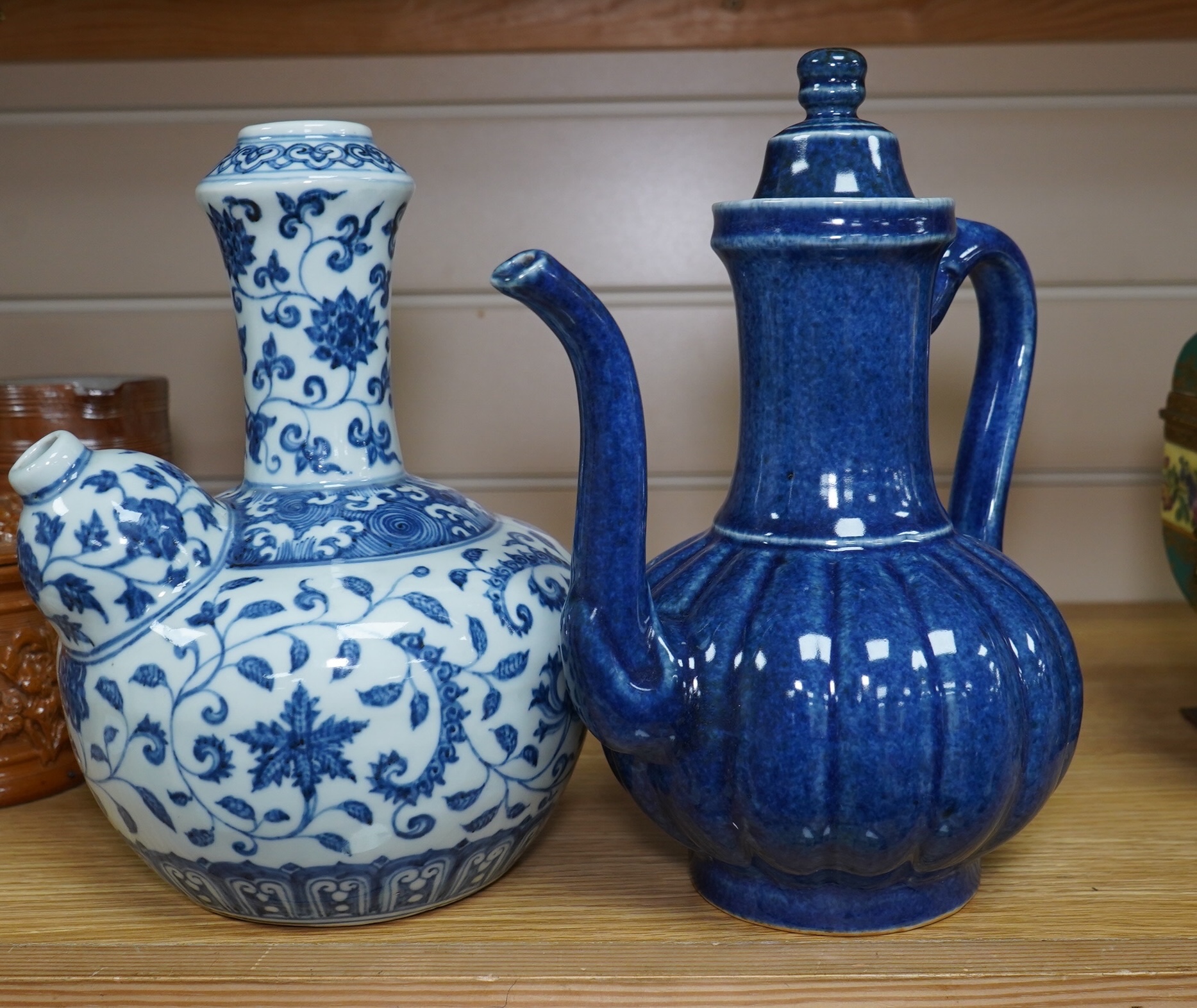 A Chinese porcelain powder blue ewer with cover and a similar blue and white example, largest 25cm high. Condition - good